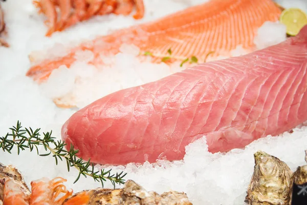 Fresh tuna filet on display. Fish market, showcase with fish. Retail sale, marketplace. Fresh fish fillets of salmon, butterfish and tuna. Healthy seafood concept.