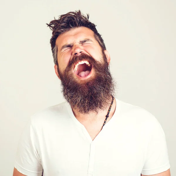 Portrait of angry screaming man. Screaming bearded brutal. Feeling angry. Stressed furious bearded man shouting. Face expression. Crazy man with beard. Negative emotions, problems.