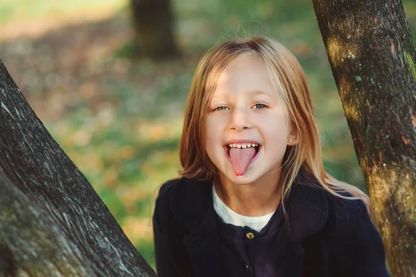 Pretty Schoolgirl Having Fun Outdoors Little Girl Shows Tongue Happy — Stock Photo, Image