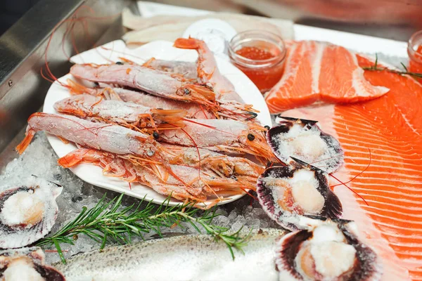 Fish food at shop, close up. Raw fish ready for sale in the supermarket. Showcase with chilled red fish in grocery store. Market place, showcase with sea food. Retail sale, marketplace.