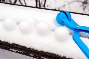 Kartopu oyunu. Açık havada. Kartopu yapıcı ile kartopları. Karlı çocuk kış oyunları. Kar topları için sevilen oyuncakçı.