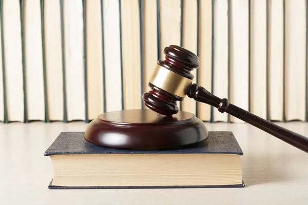 Concepto de ley. Juez de madera martillo con libros de leyes sobre la mesa en un tribunal u oficina de aplicación de la ley . — Foto de Stock