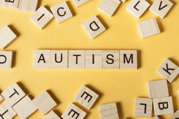 Text AUTISM on wood cubes. Wooden abc