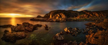 Colorful sunset at rocky coastline of Point of Sleat, Isle of Skye, Scotland