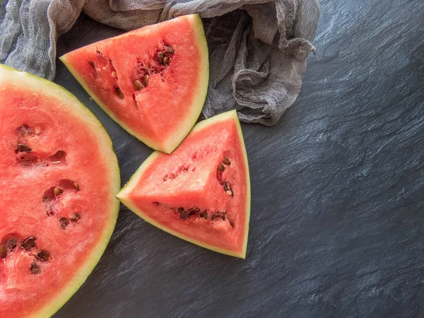 stock image ripe red watermelon on a dark background Summer food background healthy eating. eco-friendly products. organic fruits. copyspace. Organic Food. Style Top View