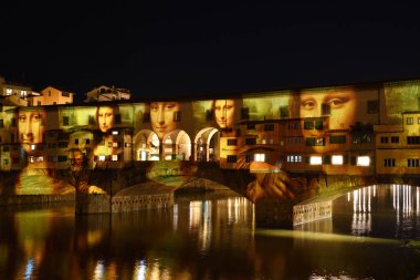 Italy, Florence, December 2018: La Gioconda by Leonardo da Vinci projected on the Ponte Vecchio in Florence, in occasion of F-Light - Festival of Lights, during Christmas season. Italy clipart