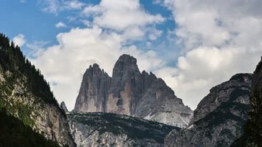 Bulutlar Tre Cime di Lavaredo dağ grubunun üzerinde hareket ediyor veya Dobbiaco yakınlarındaki Valle di Landro 'da görülen Drei Zinnen. Seksi Dolomitler, Güney Tyrol, İtalya. Zaman aşımı, 4K UHD Video. durağan kamera