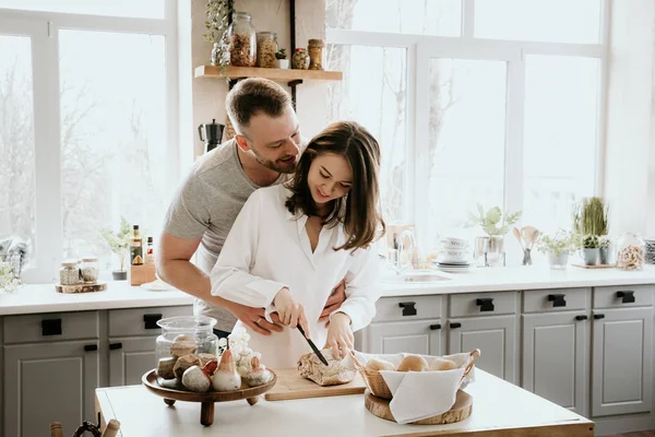 Romantic young couple cooking together in the kitchen,having a great time together.