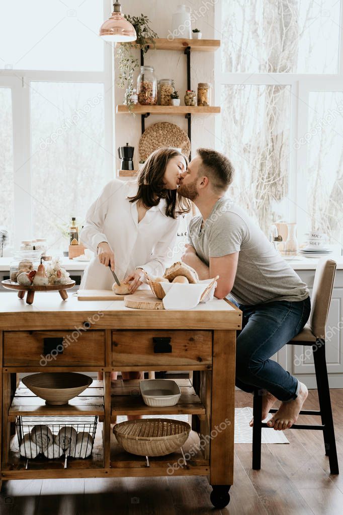 Romantic young couple cooking together in the kitchen,having a great time together.