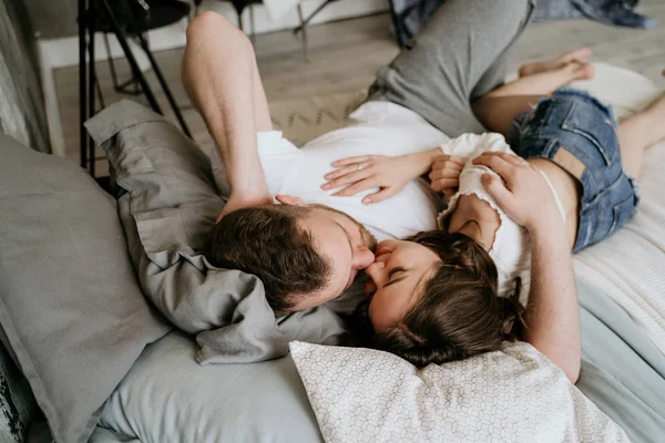 Couple in love in the bedroom. Slender brunette. Stylish interior. — Stock Photo, Image