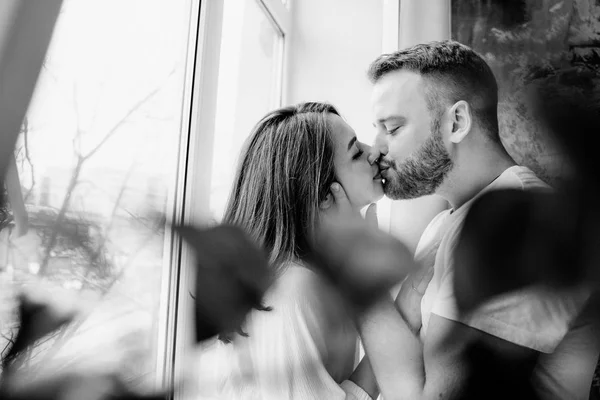 Couple in love in the bedroom. Slender brunette. Stylish interior. — Stock Photo, Image