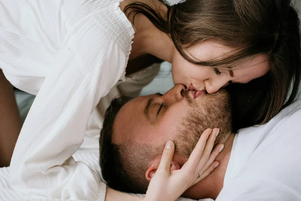 Um casal apaixonado no quarto. Morena esbelta. Interior elegante . — Fotografia de Stock