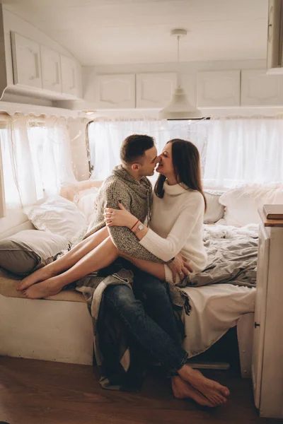 Couple in love in a trailer on bed