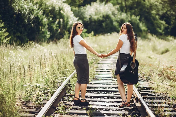 Cute sisters in a park — Stock Photo, Image