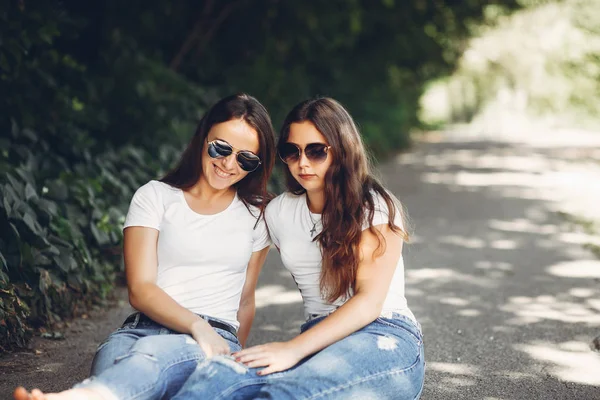 Cute sisters in a park — Stock Photo, Image