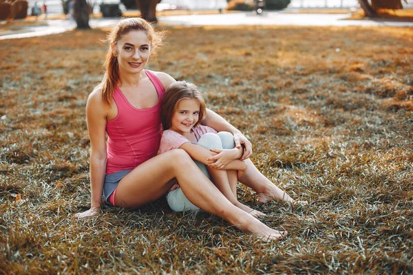 Sports family in a summer park — Stock Photo, Image