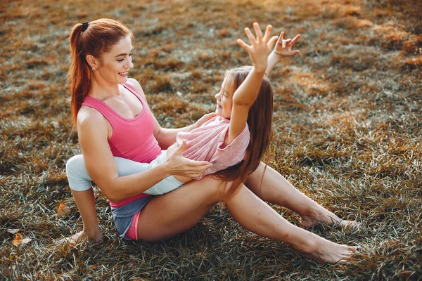 Sports family in a summer park — Stock Photo, Image