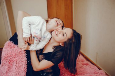 Anne ile kızı yatağa oturmuş