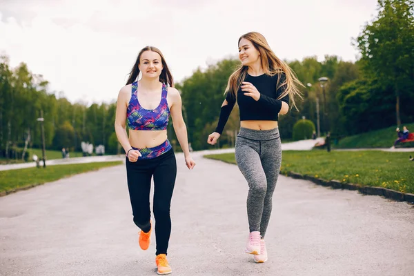 Sports girls in a park — Stock Photo, Image