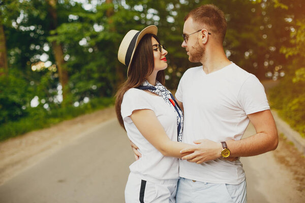 Beautiful couple spend time in a summer park