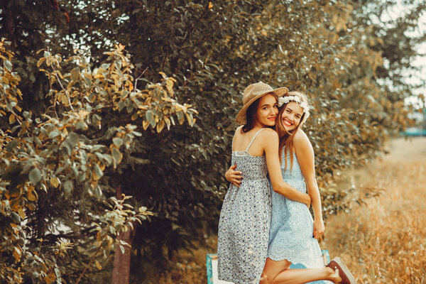Beautiful girls have a rest in a field