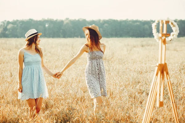 Beautiful girls have a rest in a field — Stock Photo, Image