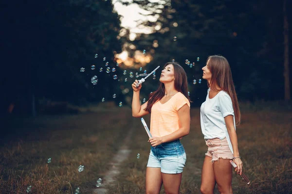 Two pretty girls in a summer park — Stock Photo, Image