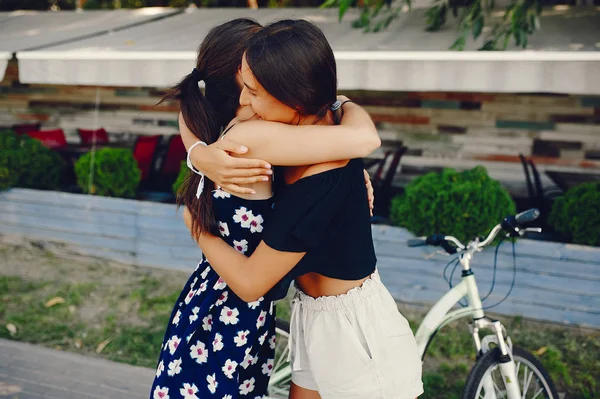 Stylish girls walking in a summer park — Stock Photo, Image