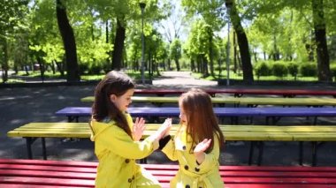 parkta birlikte oynayan iki kız kardeş