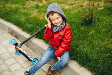 Bir parkta bir çim üzerinde oynayan sevimli çocuk