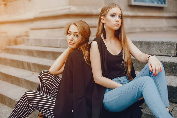 Ragazze di moda sedute in una città estiva — Foto Stock