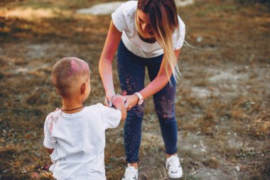 Anne ve oğlu yaz parkında oynuyorlar.