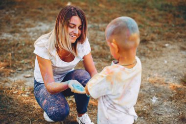 Anne ve oğlu yaz parkında oynuyorlar.