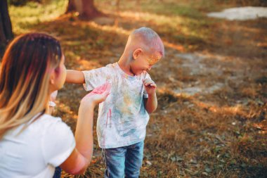 Anne ve oğlu yaz parkında oynuyorlar.