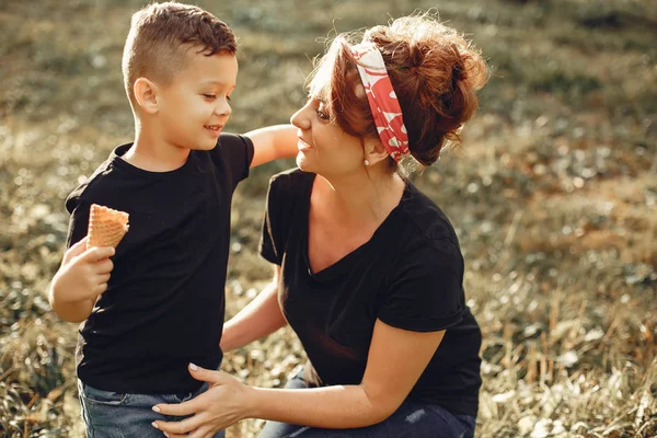 Mother with son playing in a summer park