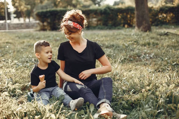 Mother with son playing in a summer park