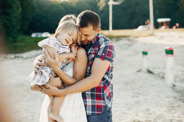 Family with daughter playing on a sand — Stock Photo, Image