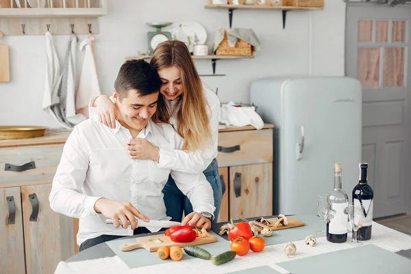 Beautiful couple prepare food in a kitchen — Stock Photo, Image