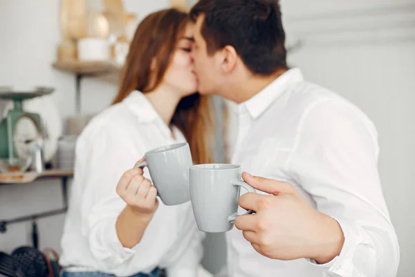 Beautiful couple spend time in a kitchen — Stock Photo, Image