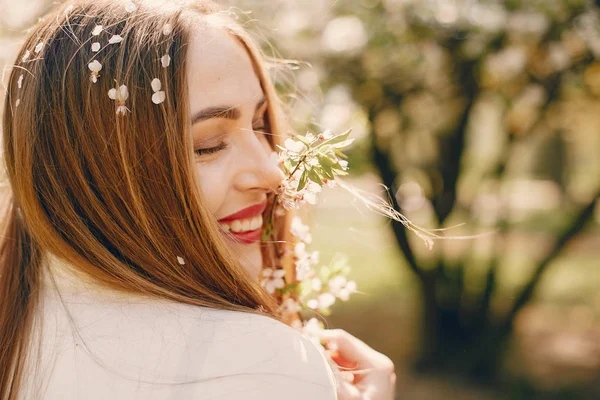 Menina elegante e elegante em um parque de primavera — Fotografia de Stock