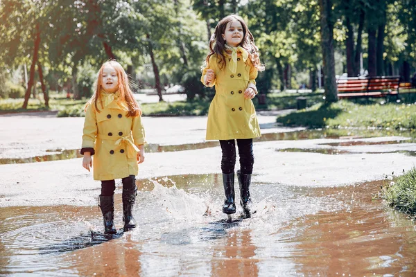 Cute kids plaiyng on a rainy day — Stock Photo, Image