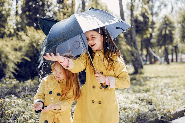 Cute kids plaiyng on a rainy day — Stock Photo, Image