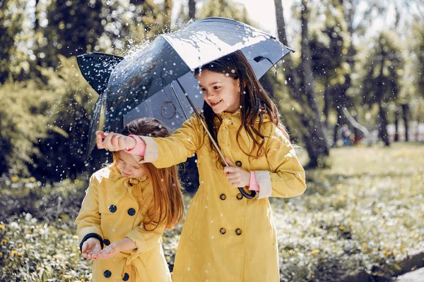 Cute kids plaiyng on a rainy day — Stock Photo, Image