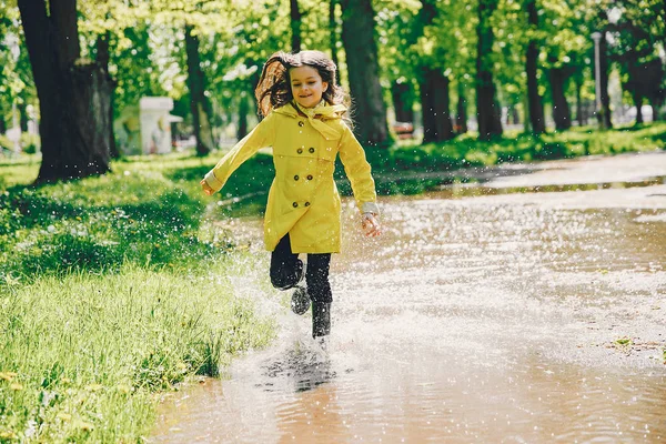 Cute girl plaiyng on a rainy day — Stock Photo, Image