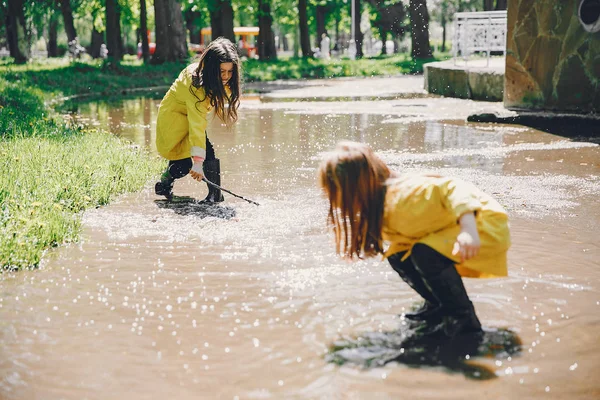 Cute kids plaiyng on a rainy day — Stock Photo, Image