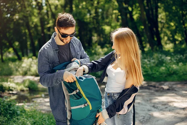 Cute couple have a rest in a summer forest — Stock Photo, Image