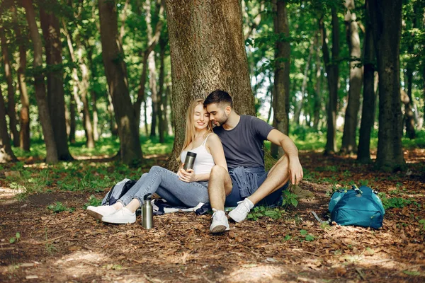 Χαριτωμένο ζευγάρι να ξεκουραστούν σε ένα καλοκαιρινό δάσος — Φωτογραφία Αρχείου