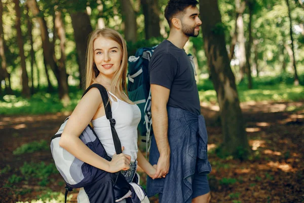 Cute couple have a rest in a summer forest — Stock Photo, Image