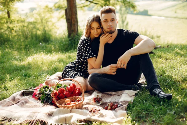 Beautiful couple spend time in a summer field — Stock Photo, Image