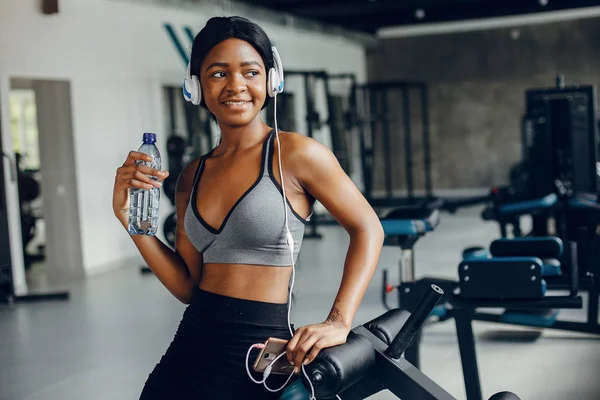 A beautiful black girl is engaged in a gym